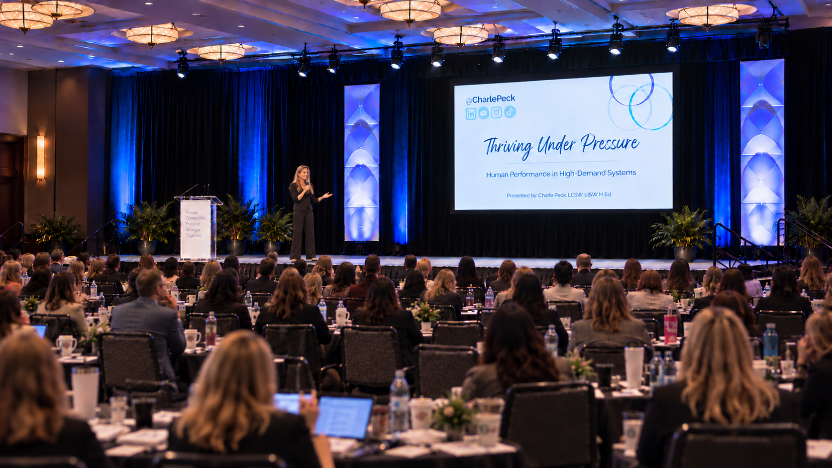 Charle Peck presenting Thriving Under Pressure to a conference audience